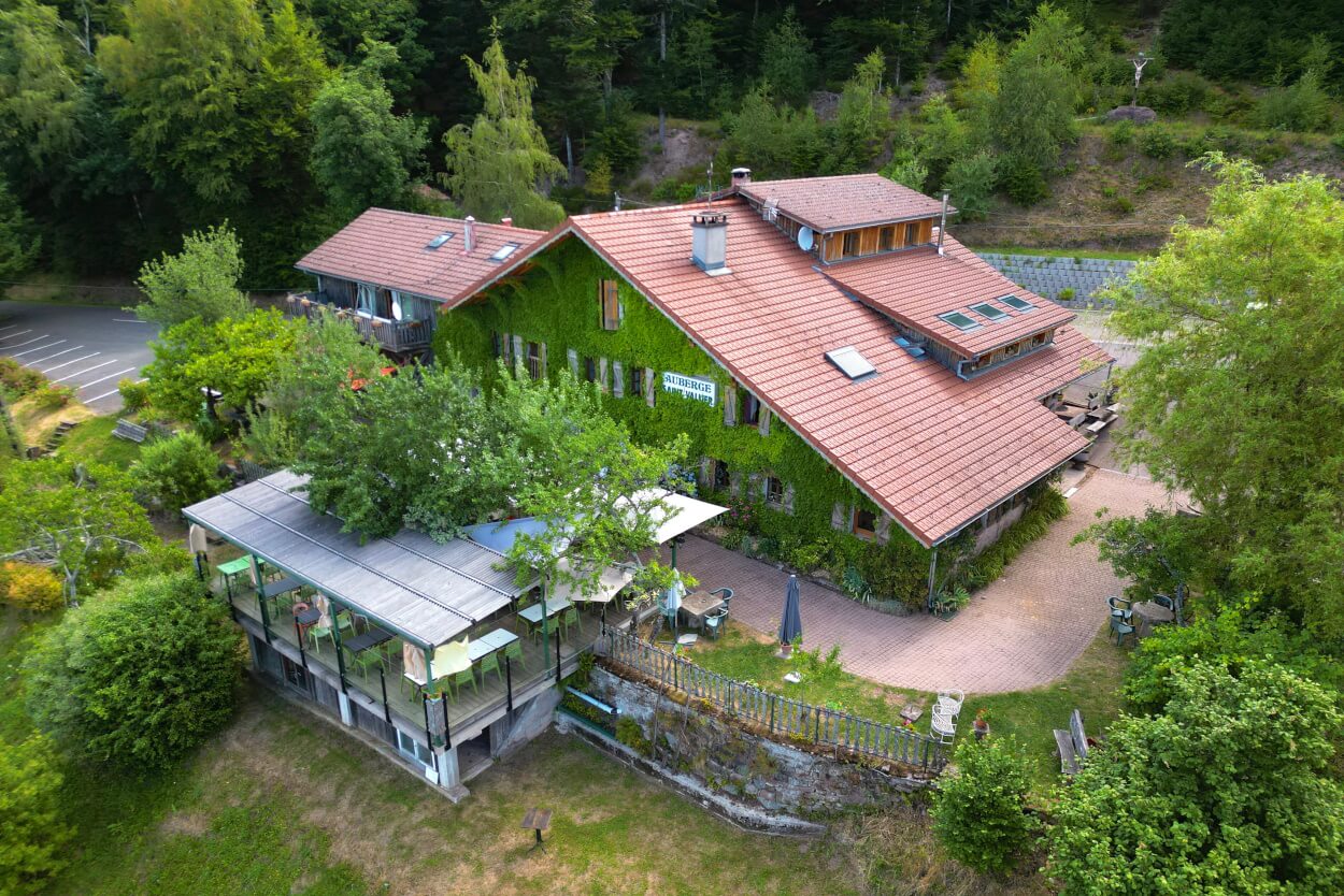 Vue aérienne de l’Auberge de la Ferme Saint-Vallier, de sa terrasse et de la forêt vosgienne